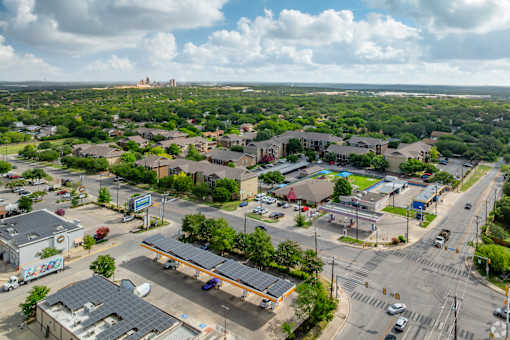 A view of a town with a large building in the distance at The Villages at Lost Creek Apartments, San Antonio, Texas