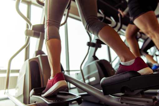 A person is using a treadmill in a gym.