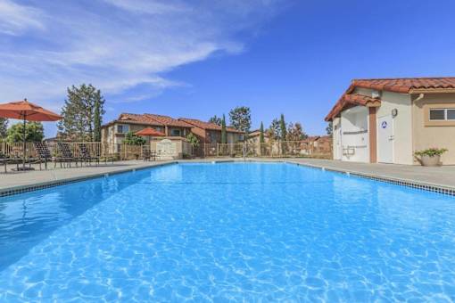 a swimming pool with buildings in the background at Riverview Springs, Oceanside, California