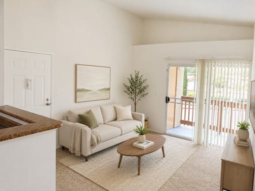 A living room with a couch, a coffee table, and a painting on the wall.
