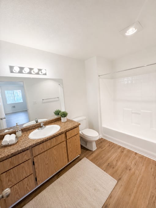 A bathroom with a brown countertop and a white toilet.