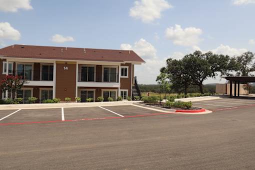 A building with the number 14 on it is surrounded by a parking lot.