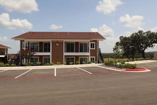 A building with a parking lot in front of it.