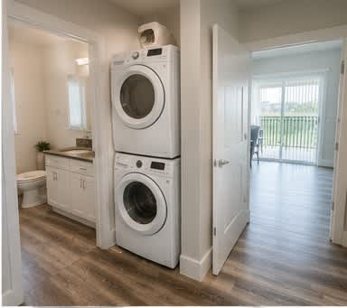 A white washing machine and dryer in a laundry room.