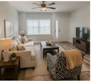 A living room with a couch, chair, and television.