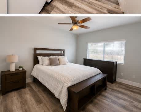 A bedroom with a bed, nightstand, and window.