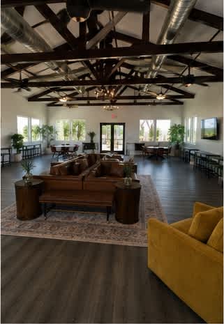 A living room with a yellow couch and a wooden coffee table.