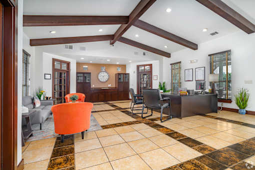 A living room with a brown and white checkered floor at The Villages at Lost Creek Apartments, San Antonio, Texas