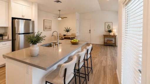 A kitchen with white cabinets and a stainless steel refrigerator.