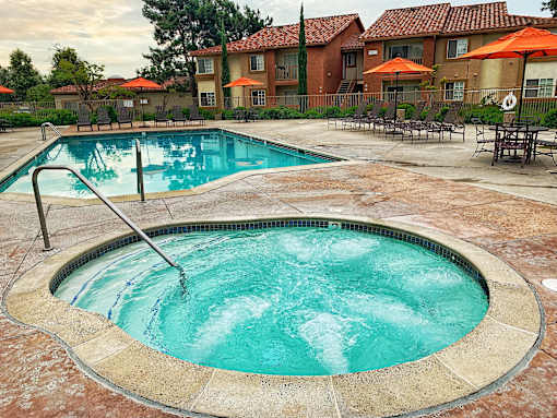 a swimming pool with a hot tub and a resort style pool at Riverview Springs, Oceanside, CA