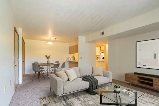 A living room with a grey couch and a coffee table.