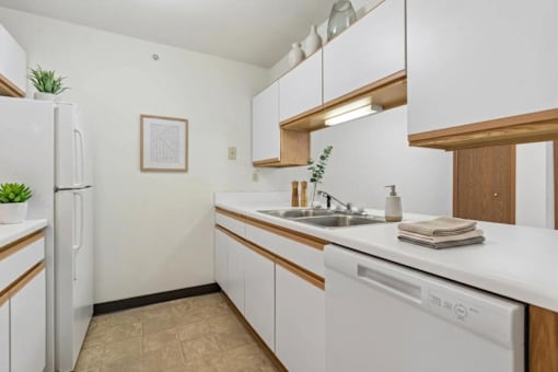 A kitchen with white appliances and wooden accents.