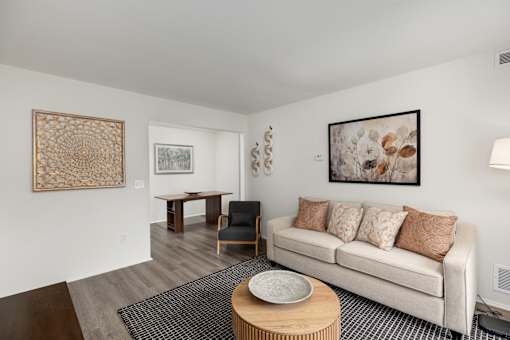 A living room with a white couch and a coffee table.