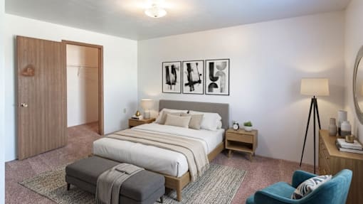 A bedroom with a large bed, a bench, and a chair.