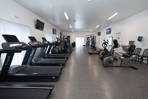 A gym with treadmills and exercise bikes.