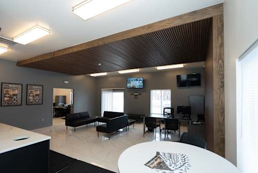 A modern living room with a black couch and a television.