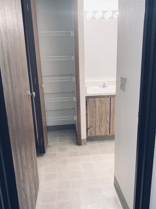 a bathroom with a closet and a sink in it