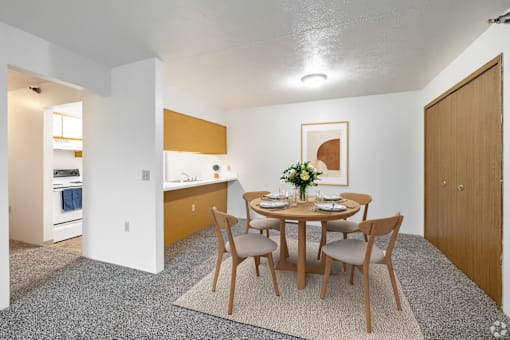 A dining room with a table set for two.