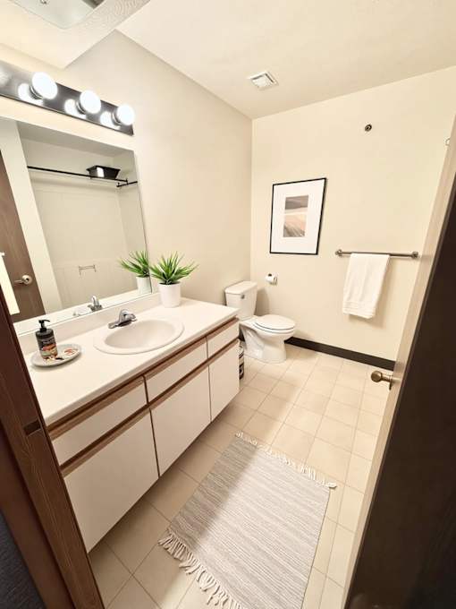 A bathroom with a white sink and a white toilet.