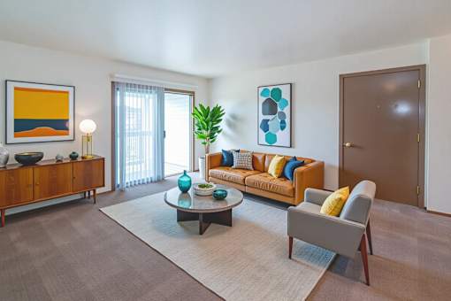 A living room with a sofa, a coffee table, and a painting on the wall.