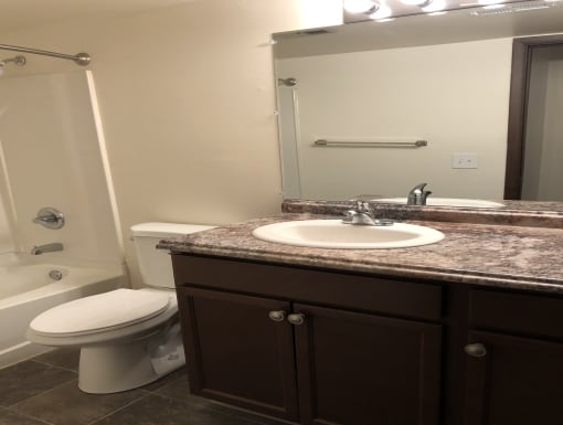 a small bathroom with a sink toilet and shower