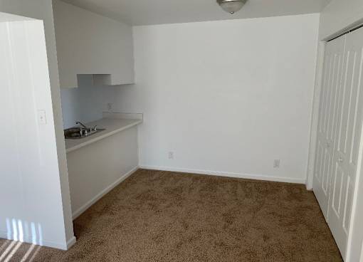 an empty room with a sink and a counter in it