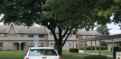 a white car parked in front of an apartment building