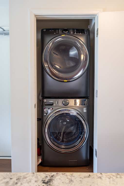 A washing machine is built into a cabinet.