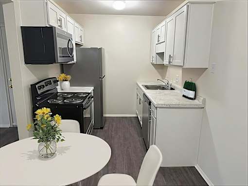 A small kitchen with a table and chairs.