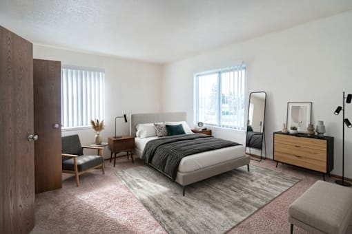 A bedroom with a bed, nightstand, chair, and window.