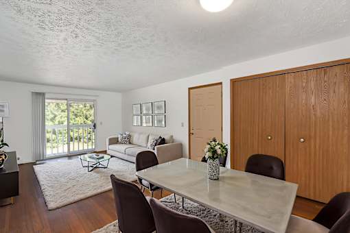 A dining room with a table and chairs.