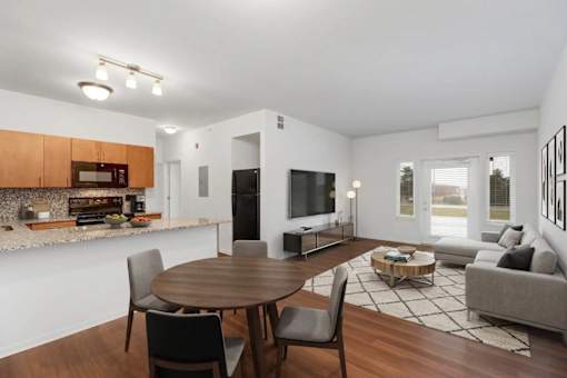 A modern dining room with a wooden table and chairs.