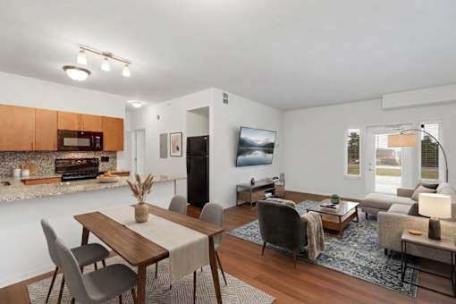 A modern dining room with a wooden table and chairs.