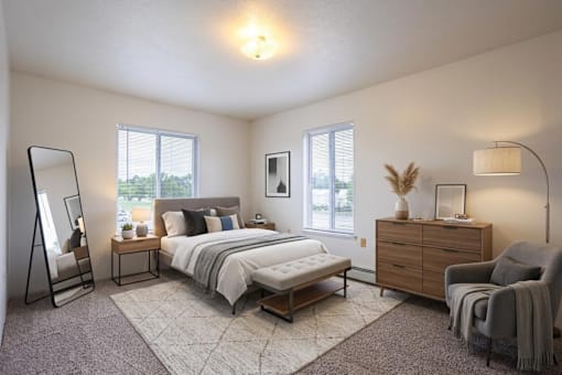A bedroom with a large bed, a chair, and a dresser.