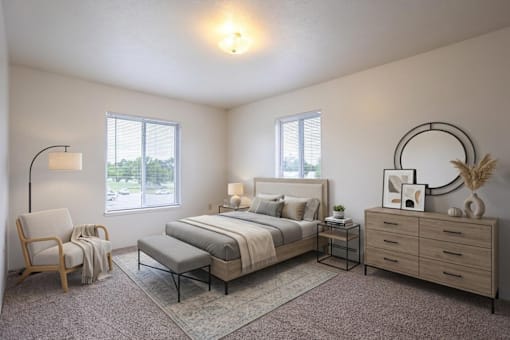 A well-lit bedroom with a large bed, a chair, and a bench.