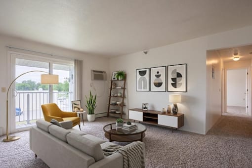 A living room with a grey couch, a yellow chair, a coffee table, and a bookshelf.