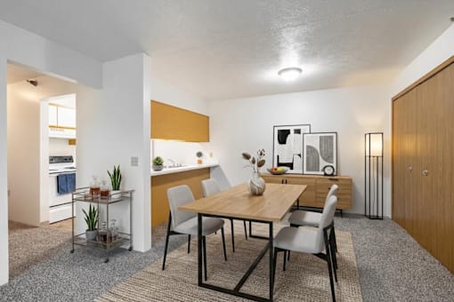 A dining room with a table and chairs.