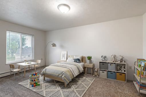 A bedroom with a bed, nightstand, and a window with blinds.