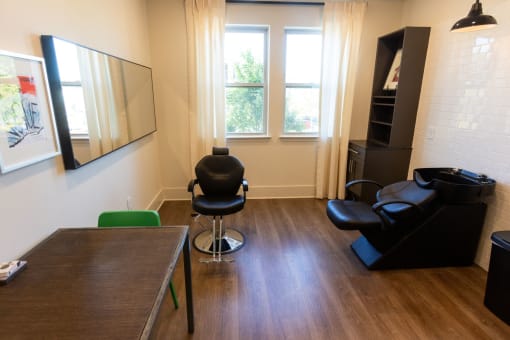 a living room with a wooden floor and a table and chairs