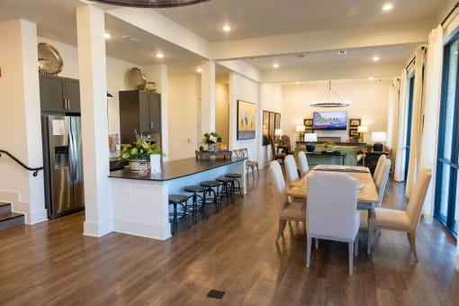 a dining room and living room with a table and chairs