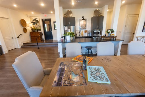 a dining room table with a kitchen in the background