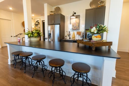 a kitchen with a counter top and some bar stools