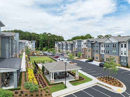 A view of a residential area with houses and a parking lot.