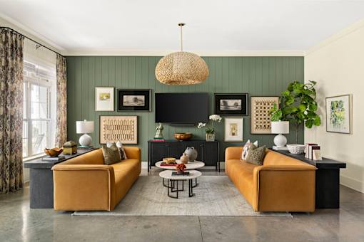 A living room with two yellow sofas and a coffee table.