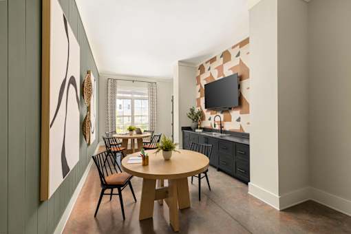 A modern dining room with a wooden table and chairs.