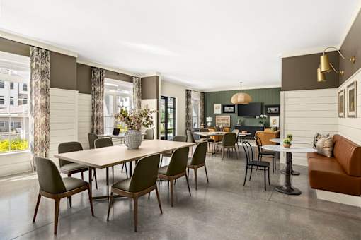 A dining room with a table and chairs.