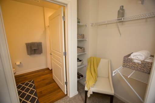 A small room with a white chair and a yellow blanket.