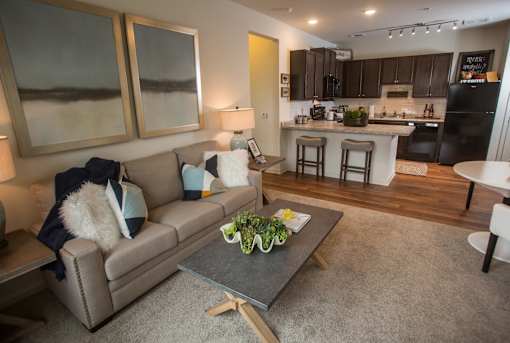 A modern living room with a grey couch and a coffee table.