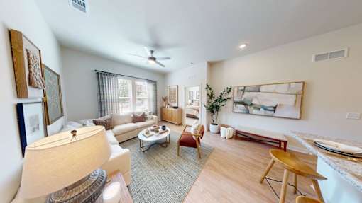 A living room with a couch, chair, and table.