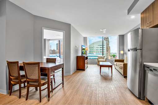 A modern kitchen with a dining table and chairs.